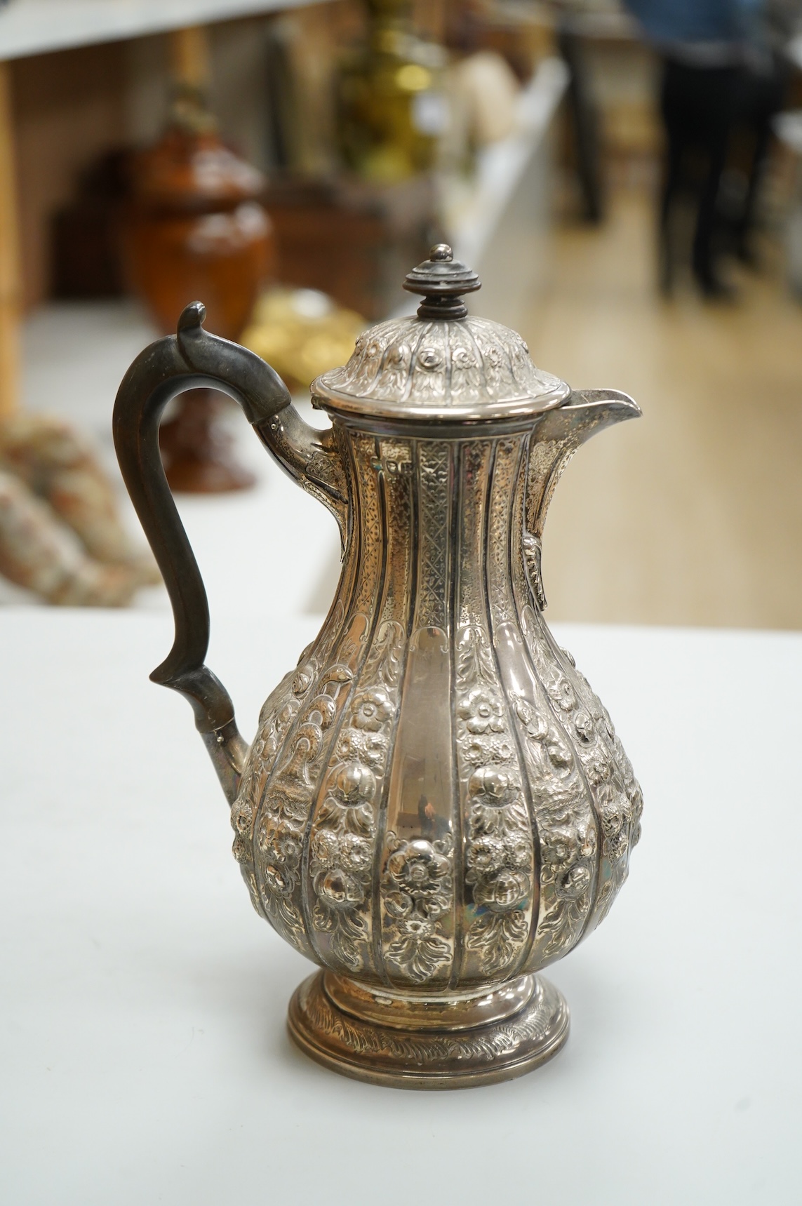 A late Victorian embossed silver hot water jug, of baluster form, F.B. Thomas & Co, London, 1892, height 25.5cm, gross weight 18.4oz.